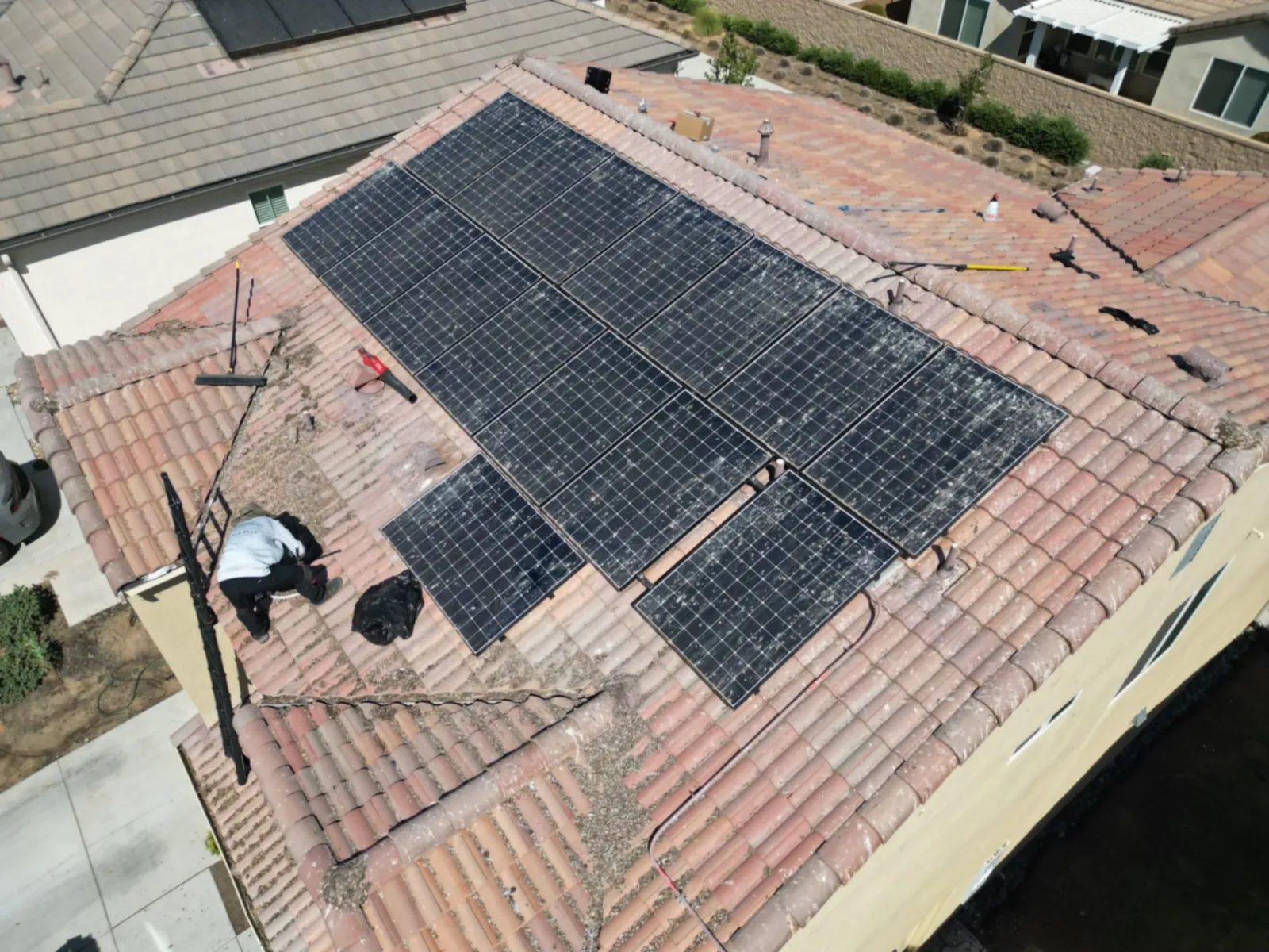 Aerial view of rooftop solar panels being serviced