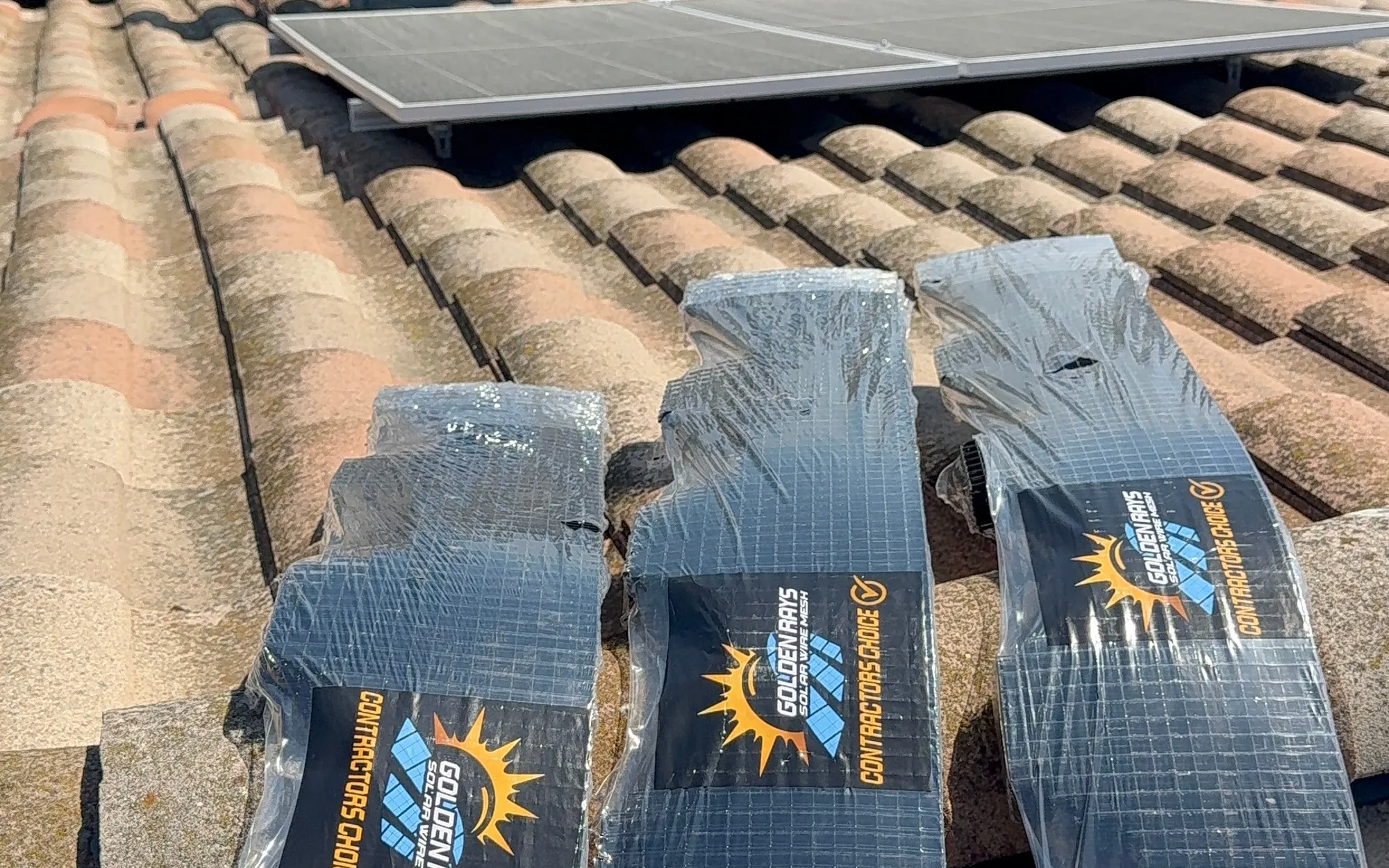 Golden Rays branded solar wire mesh on a tile roof at Villa Torino apartments in downtown San Jose, a large multi-building solar bird proofing project